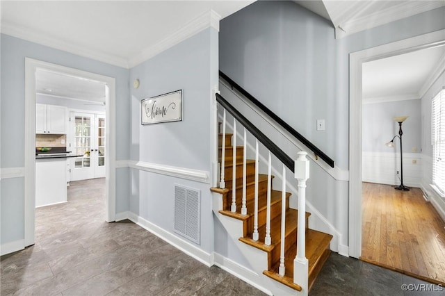 stairs featuring ornamental molding, plenty of natural light, and baseboards
