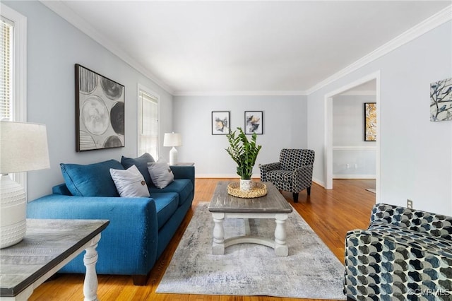 living room with crown molding, wood finished floors, and baseboards