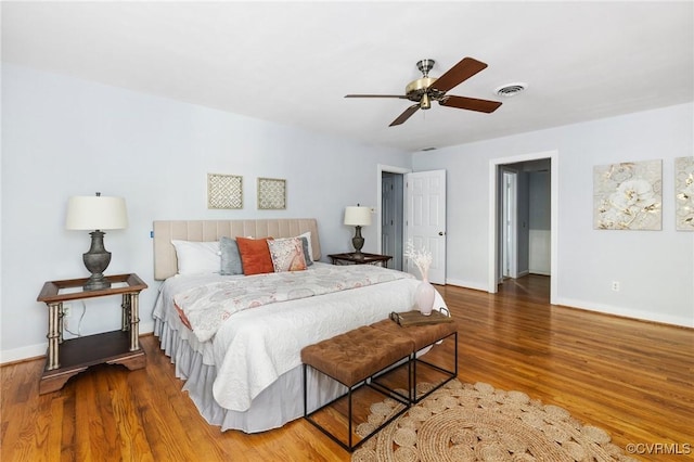 bedroom featuring wood finished floors, baseboards, and ceiling fan