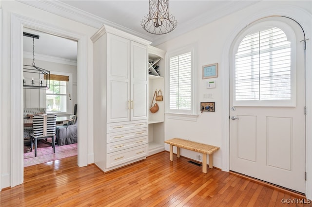 mudroom featuring a chandelier, light wood finished floors, and ornamental molding