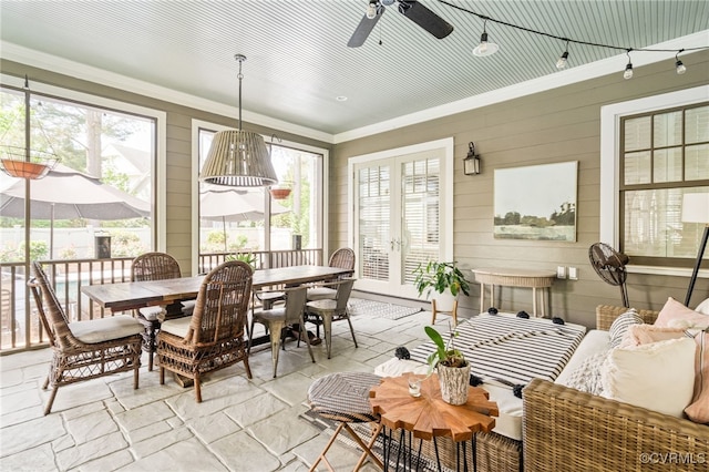sunroom with outdoor dining space, a ceiling fan, and plenty of natural light