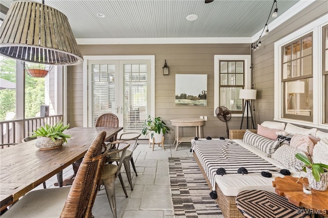 sunroom featuring french doors, plenty of natural light, outdoor dining space, and an outdoor hangout area