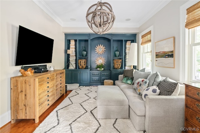 living room featuring a chandelier, wood finished floors, and ornamental molding