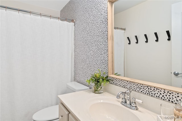 full bath featuring toilet and vanity