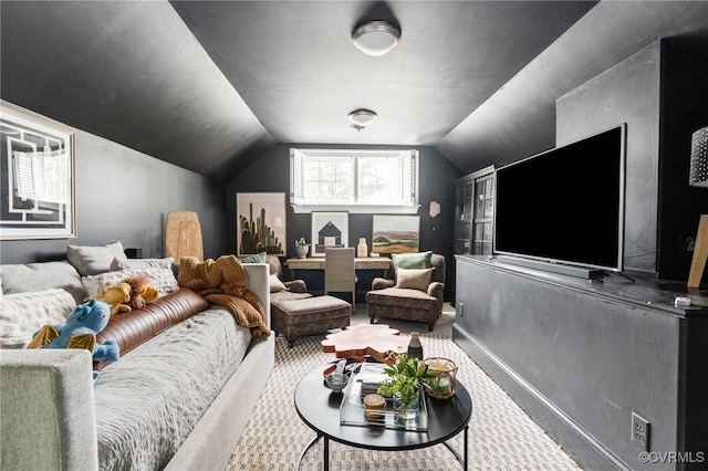 home theater room featuring carpet flooring, lofted ceiling, and baseboards