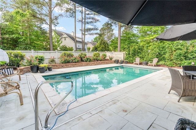 view of swimming pool with a patio area and a fenced backyard