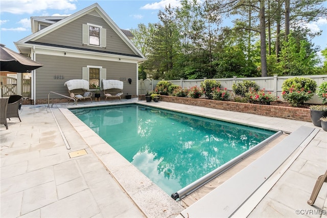 view of swimming pool with a patio area and a fenced backyard