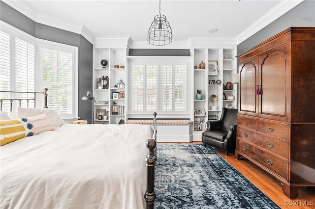 bedroom featuring light wood-style flooring and crown molding