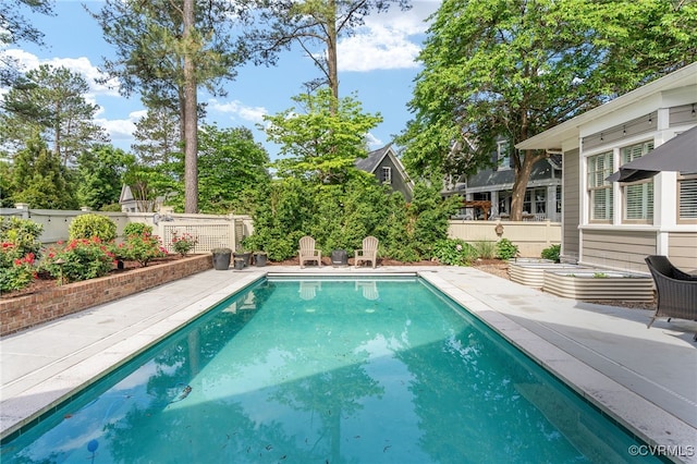 view of swimming pool with a fenced backyard and a patio area