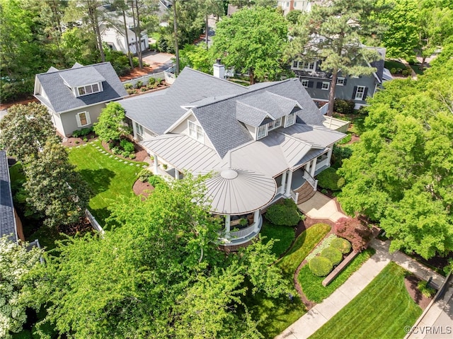 view from above of property with a tree filled landscape