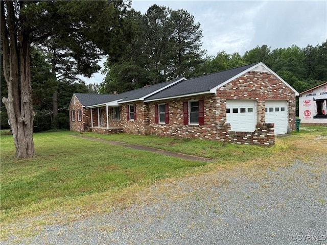 ranch-style house with a front lawn, gravel driveway, and brick siding