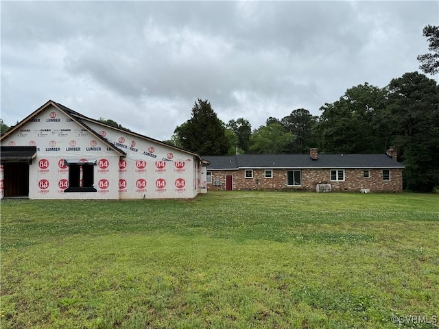 view of front of property featuring a front lawn and a chimney