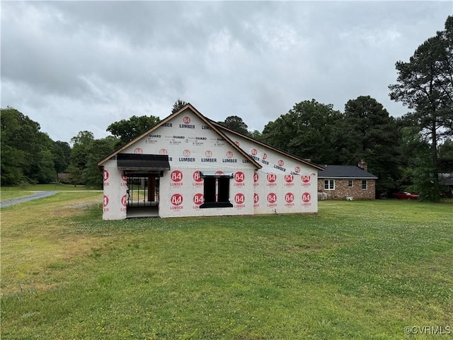 back of property featuring a yard