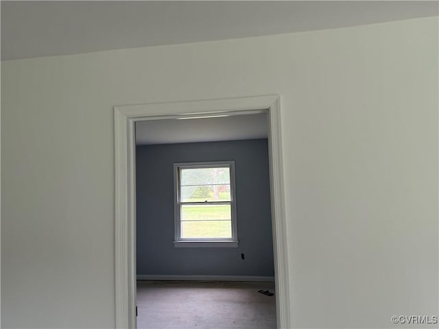 unfurnished room featuring baseboards