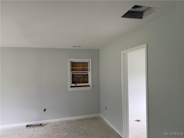 spare room with baseboards and visible vents