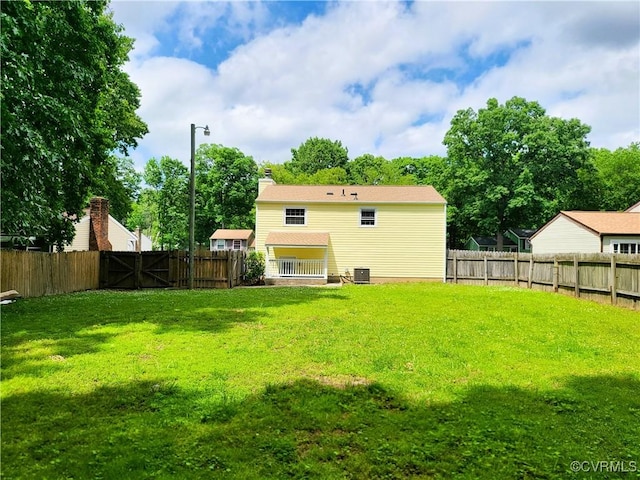 rear view of property with central air condition unit and a chimney