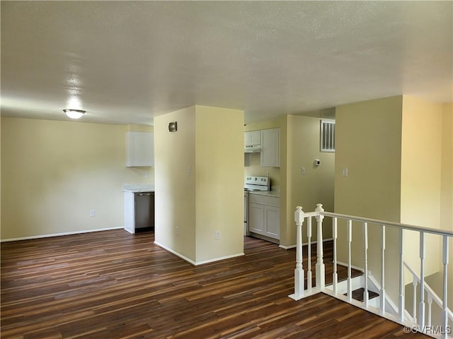 empty room featuring dark wood finished floors and baseboards
