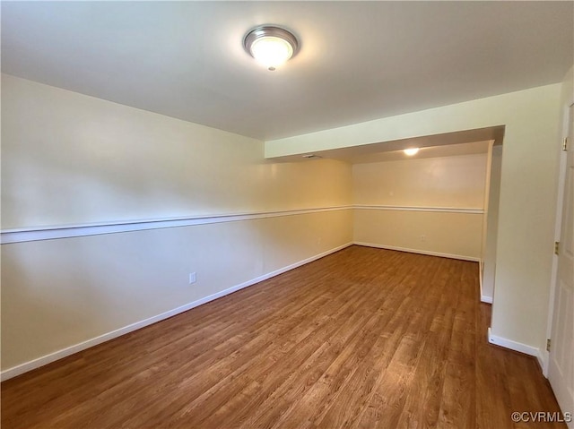 spare room with wood finished floors and baseboards