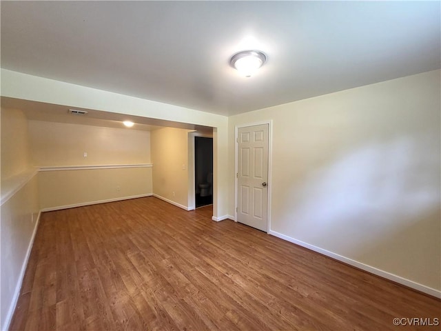empty room featuring wood finished floors and baseboards