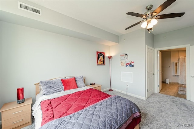 carpeted bedroom with visible vents, a ceiling fan, and baseboards