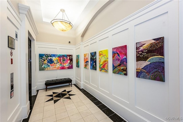 hall with a decorative wall and tile patterned floors