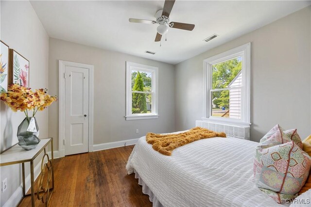 bedroom with wood finished floors, baseboards, and a ceiling fan