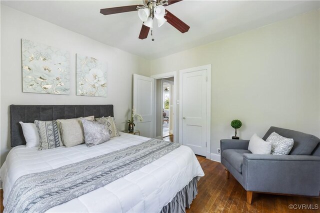 bedroom with hardwood / wood-style floors, ceiling fan, and baseboards