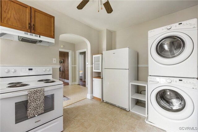 clothes washing area with stacked washing machine and dryer, a ceiling fan, and arched walkways
