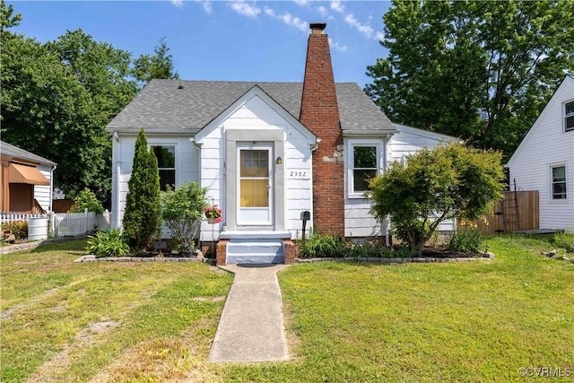 bungalow-style home featuring a shingled roof and a chimney