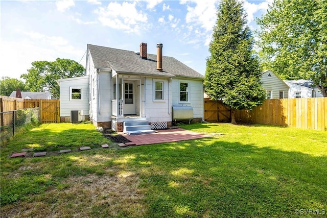rear view of property with heating fuel, a gate, a shingled roof, central AC unit, and a chimney