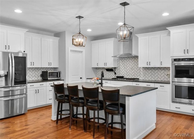 kitchen with dark countertops, appliances with stainless steel finishes, decorative backsplash, and recessed lighting