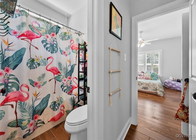 ensuite bathroom with ensuite bathroom, a ceiling fan, wood finished floors, and toilet