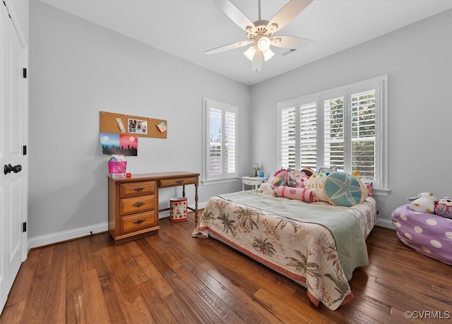 bedroom with baseboards, ceiling fan, dark wood-style floors, and visible vents