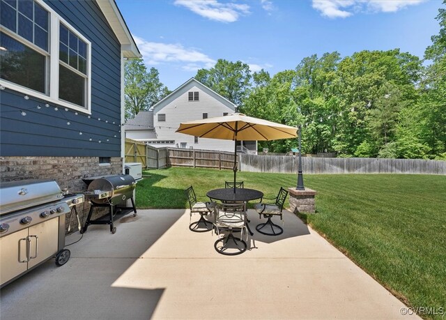 view of patio / terrace featuring a fenced backyard, outdoor dining area, and grilling area