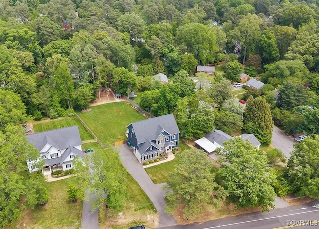 birds eye view of property featuring a view of trees and a residential view