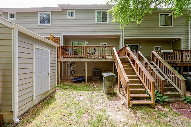 back of property with stairs and a wooden deck