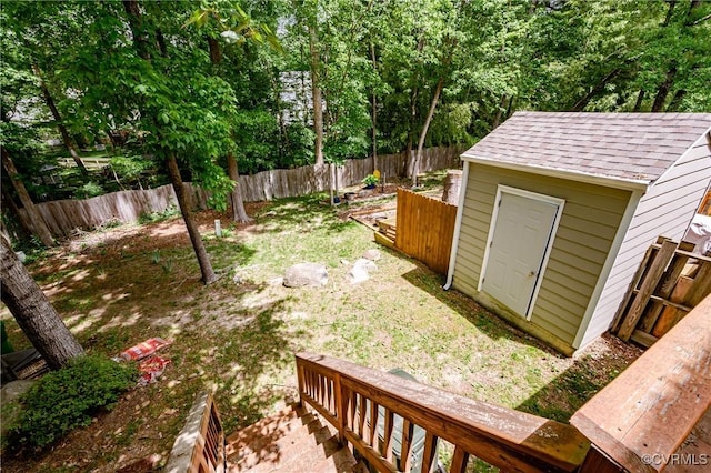 fenced backyard with a shed and an outbuilding