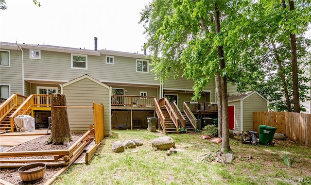 back of house with stairway, a deck, and fence