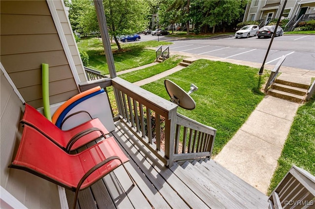 deck featuring covered porch and a lawn
