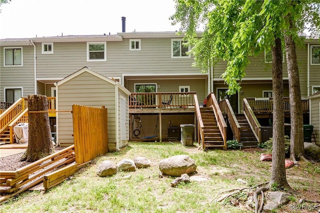 rear view of house featuring stairs and a deck