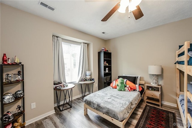 bedroom featuring wood finished floors, baseboards, and ceiling fan