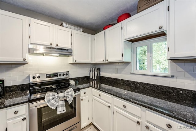 kitchen featuring stainless steel range with electric cooktop, under cabinet range hood, white cabinets, and dark stone counters