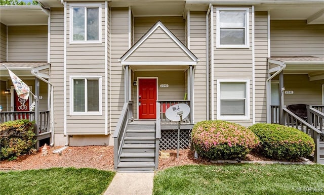 townhome / multi-family property featuring covered porch