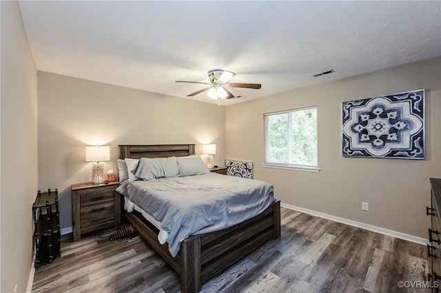 bedroom with wood finished floors, baseboards, and ceiling fan
