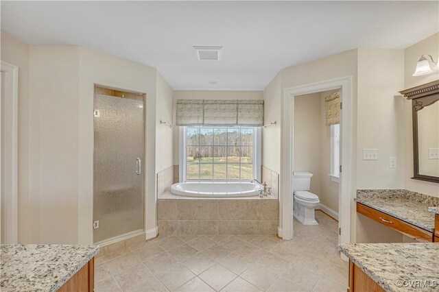 bathroom featuring toilet, a bath, a shower stall, tile patterned floors, and vanity