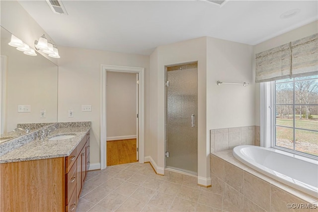 full bathroom with a stall shower, visible vents, tile patterned floors, a garden tub, and vanity