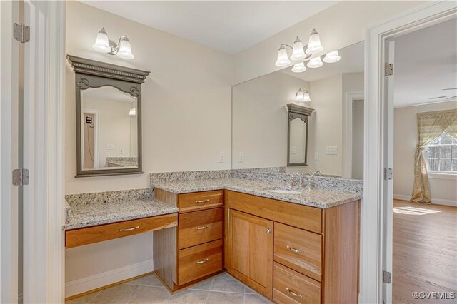 bathroom featuring baseboards and vanity