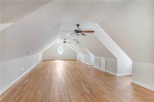 bonus room with a ceiling fan, baseboards, and light wood-type flooring