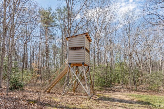 view of outdoor structure with a wooded view