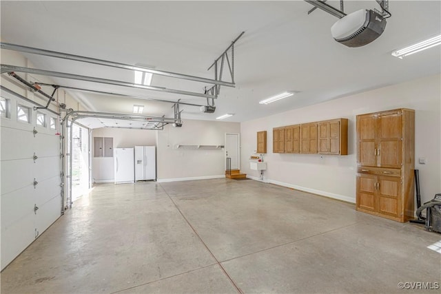 garage featuring white refrigerator with ice dispenser, freestanding refrigerator, baseboards, and a garage door opener